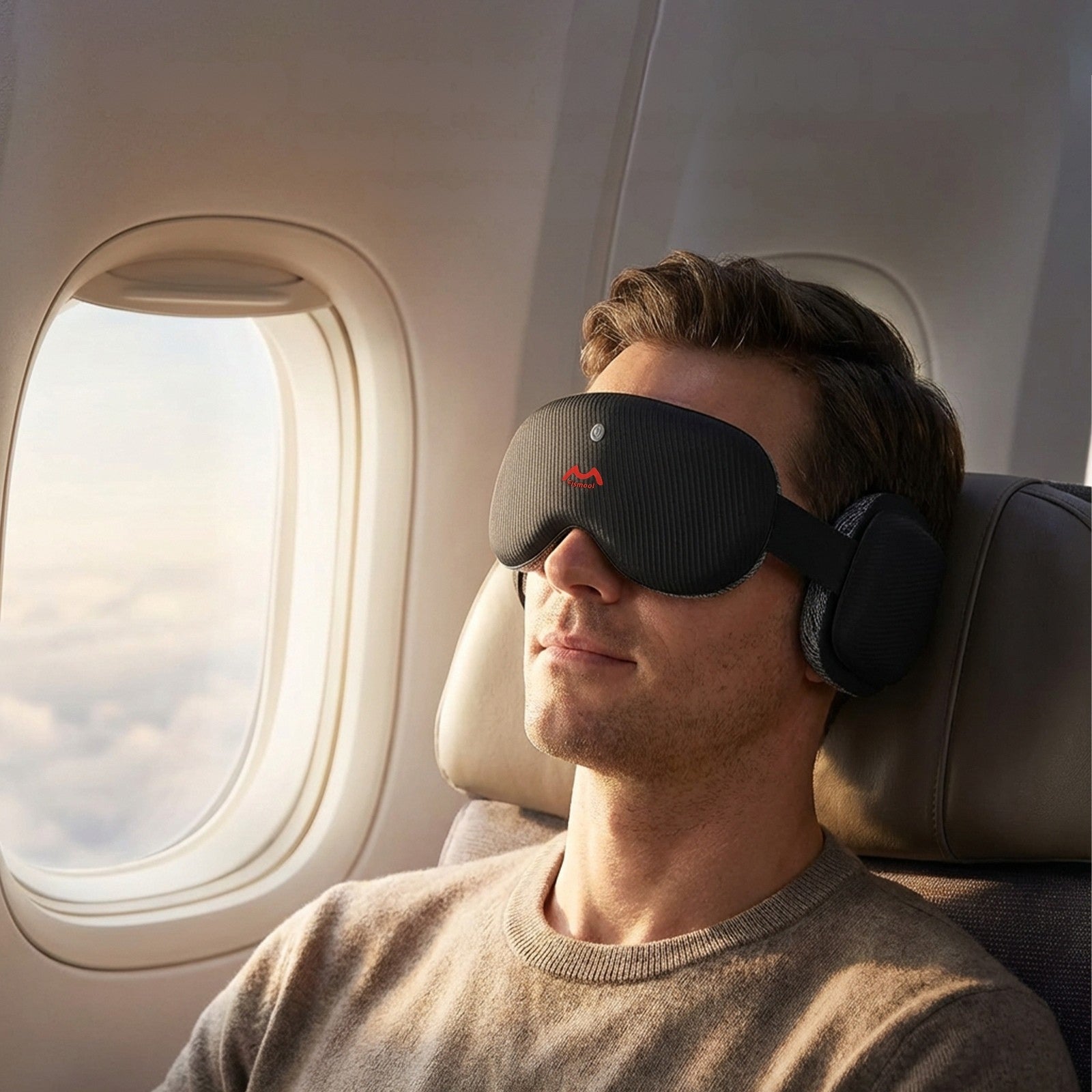 Fismool sound sleep mask black worn on an airplane, designed for travel sleep with noise blocking, deep eye cups, and comfortable Bluetooth headphones