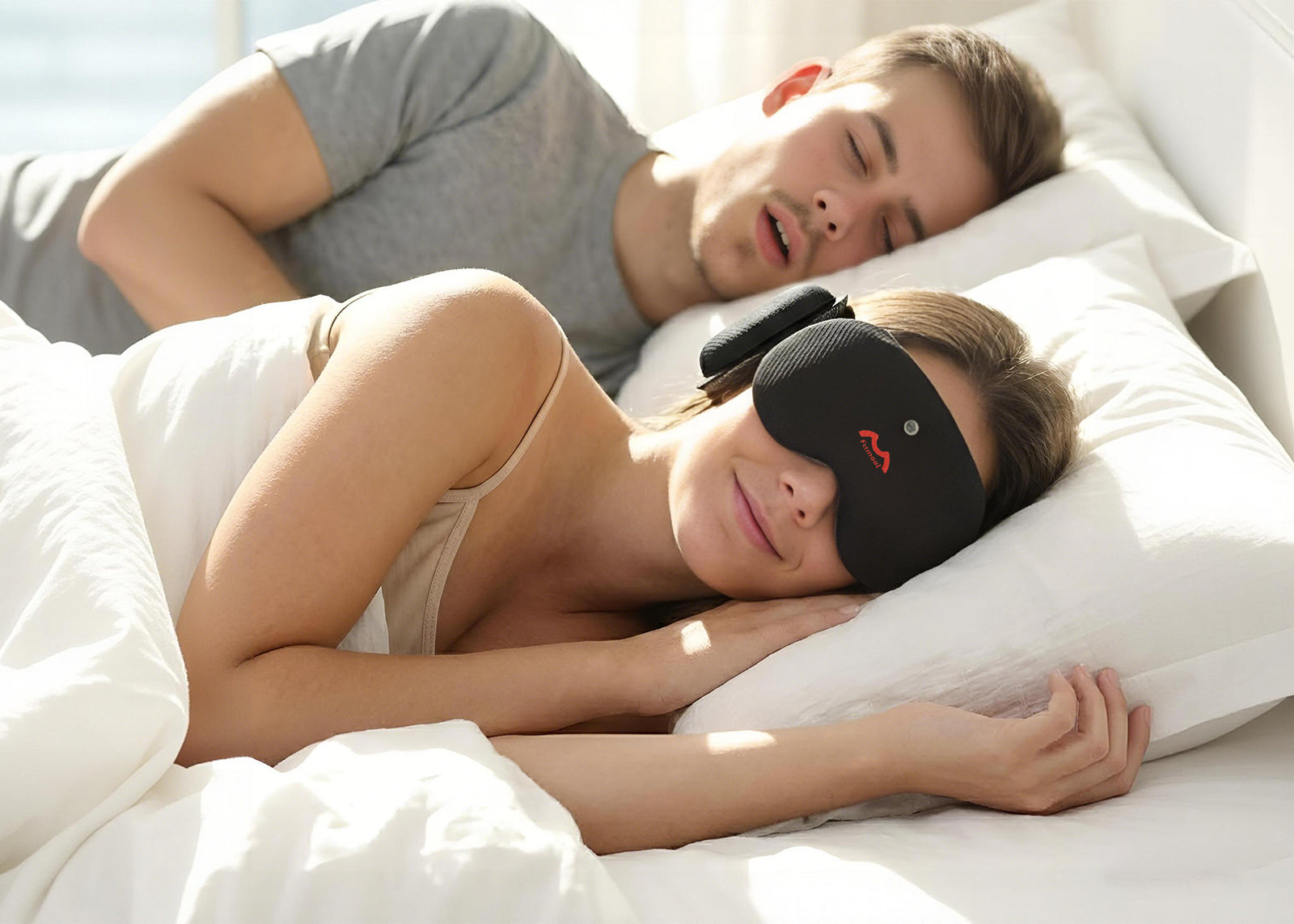 Two people lying in bed, one wearing a Fismool sound sleep mask black to block noise while sleeping