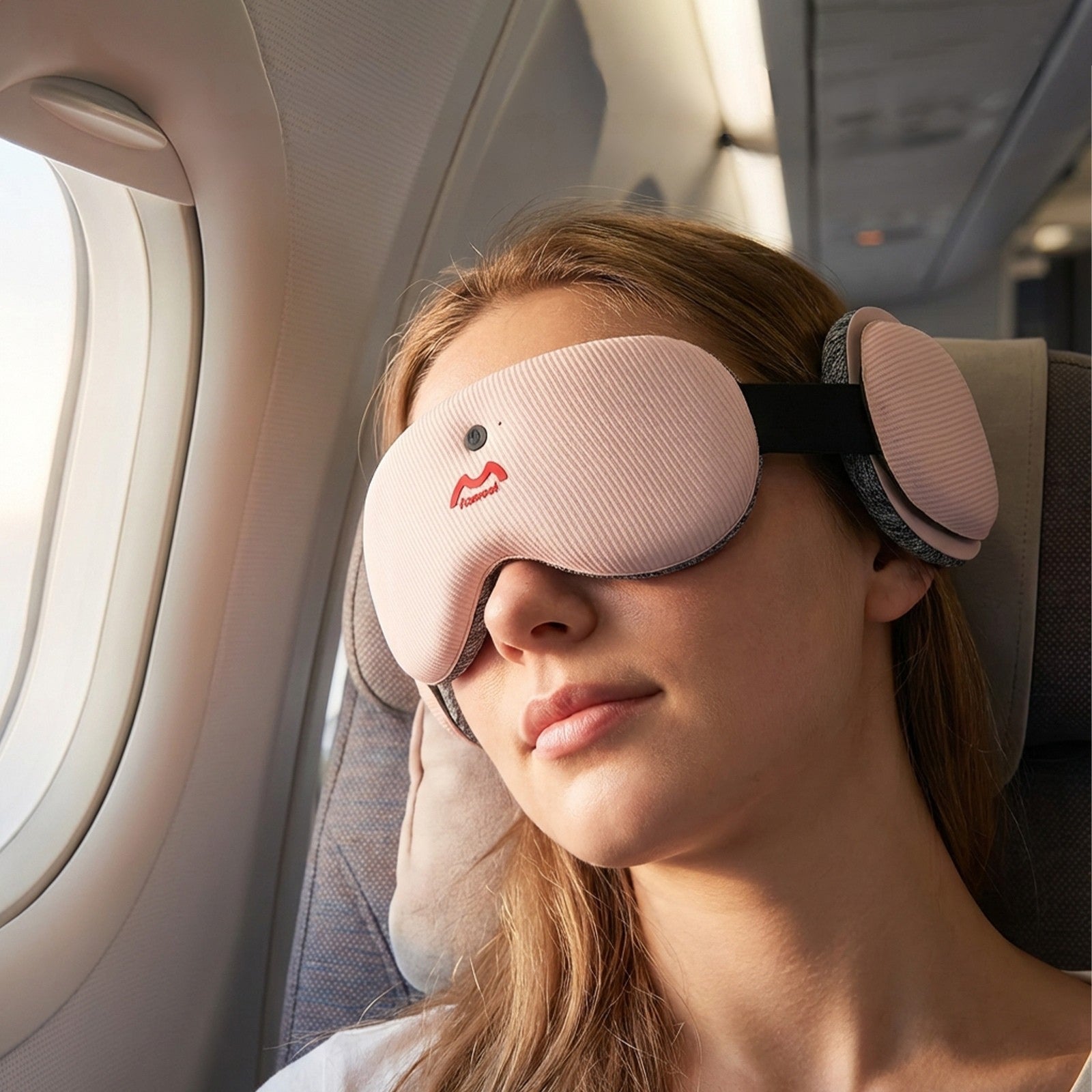 Fismool sleep mask with headphones worn on an airplane, designed for travel sleep with light blocking and Bluetooth audio