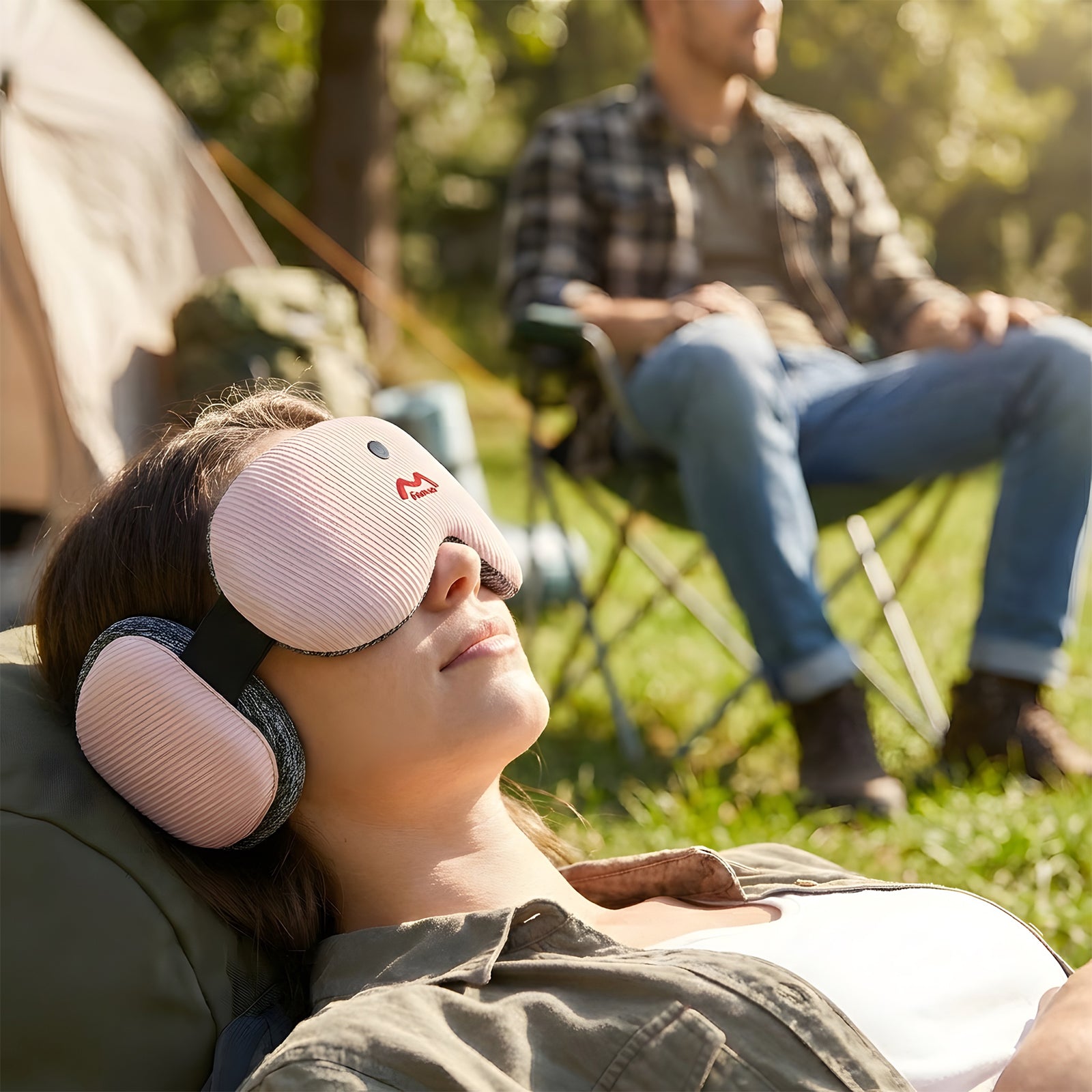 Woman resting outdoors with Fismool sound sleep mask pink, enjoying quiet time while blocking light and ambient noise.